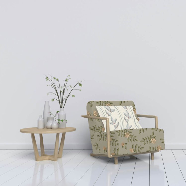 Armchair upholstered with autumn berry pattern and oak leaf cushion in minimalist room