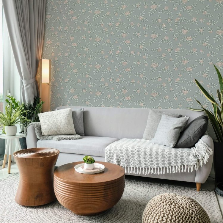 Living room with sage blue wallpaper featuring delicate pink rowan berries and soft gray furniture