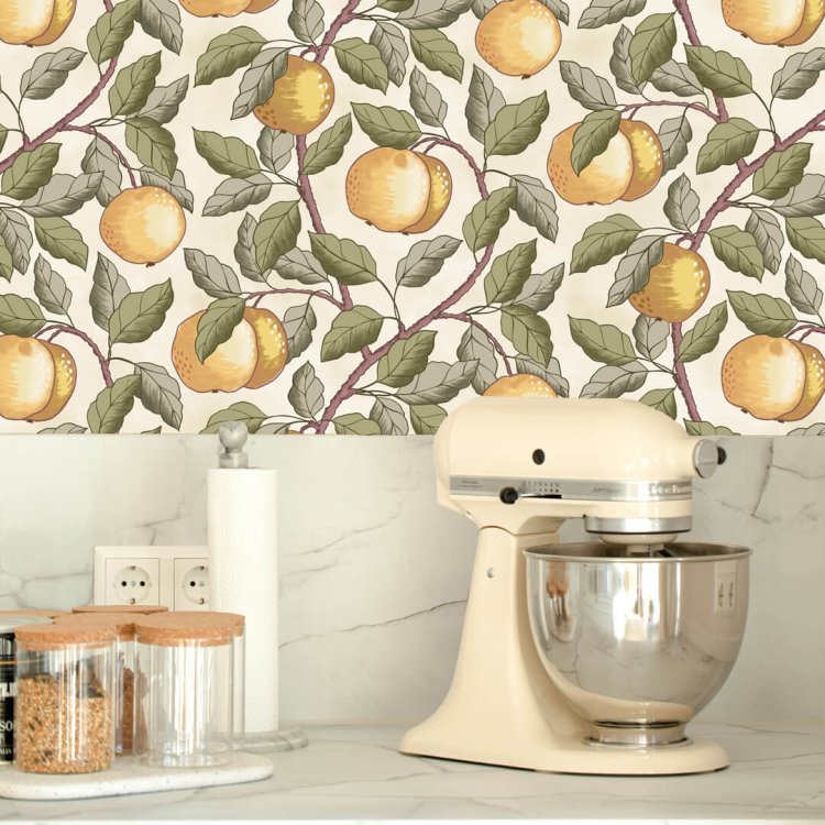 Vintage apple wallpaper in a kitchen with marble countertop and cream stand mixer